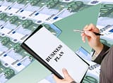 man holding business plan book 